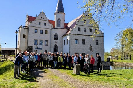 im Hintergrund das Wasserschloss Oberau und im Vordergrund die Teilnehmer