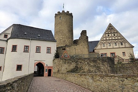 Burgtor im Vordergrund und ein Turm im Hintergrund